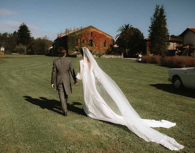 Cantabria Wedding 3 The bride and groom walking through the gardens of the finca