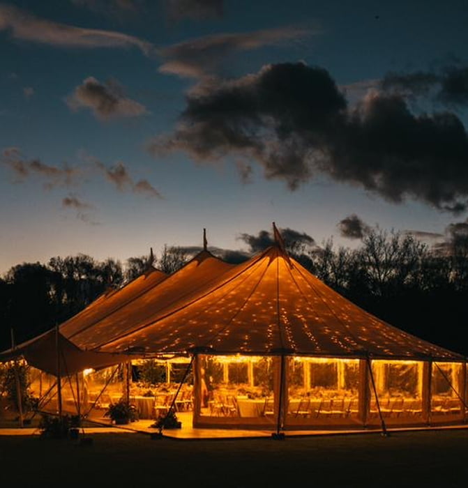 Big Weddings 3 Exterior view of a marquee lit up at night