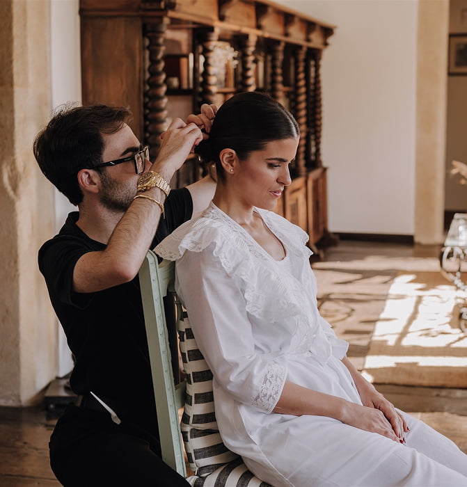 Hotel 2 Hairdresser touching up a bride's hairstyle