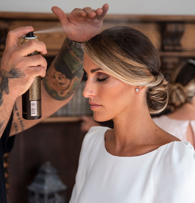 Hotel 3 Hairdresser fixing a bride's hairstyle with hairspray