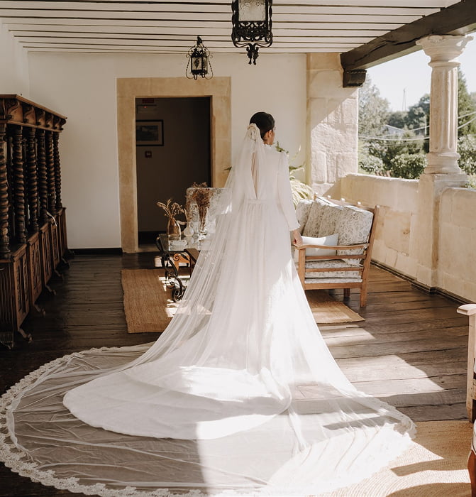 Boutique Hotel 8 Bride in a tailed dress on the porch of the palace