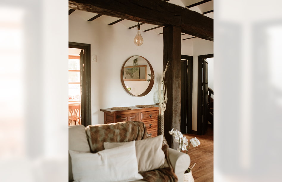 Rural House 3 Detail of the living room, decorated in white and brown tones.