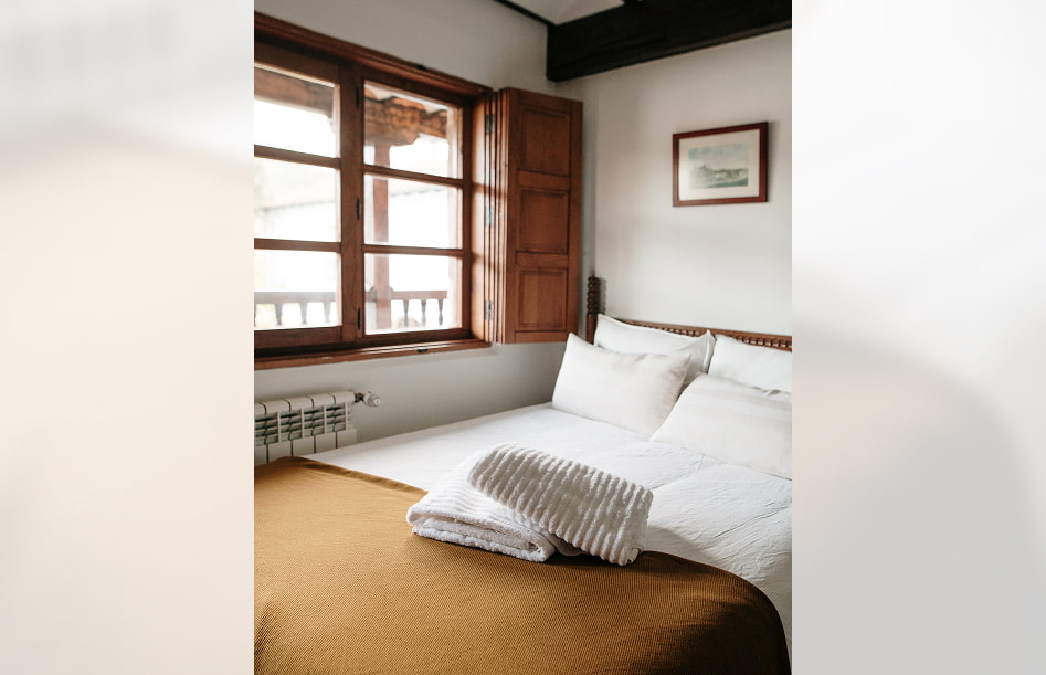 Cottage 8 Bedroom with double bed next to the window