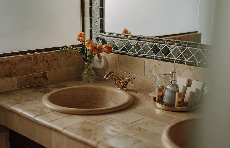 Superior Double 6 Detail of the washbasin area, with flowers and toiletries.