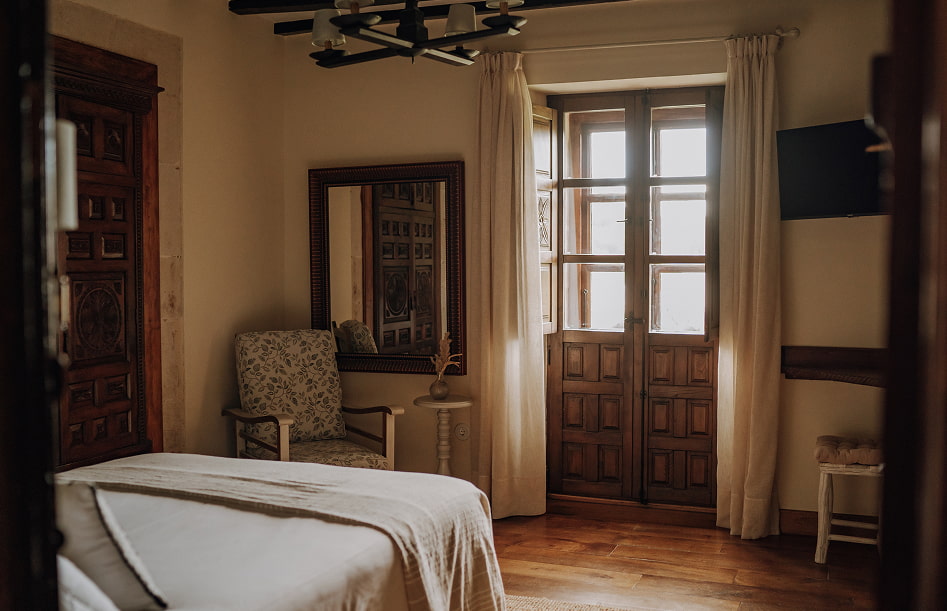 Standard Room 2 Nice corner with armchair and mirror by the bay window